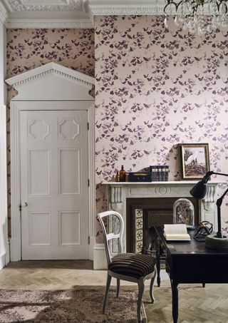 pink butterfly wallpaper in office with dark wooden desk, parquet flooring, original features