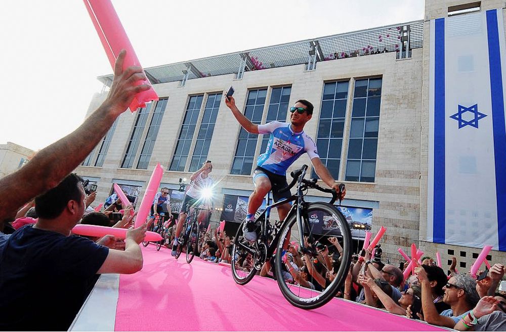 Guy Niv takes a photo of the crowd at the Giro team presentation