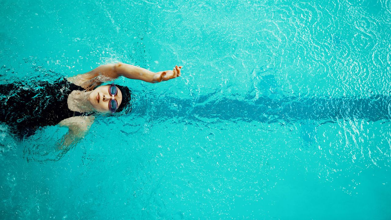 Person swimming in a pool