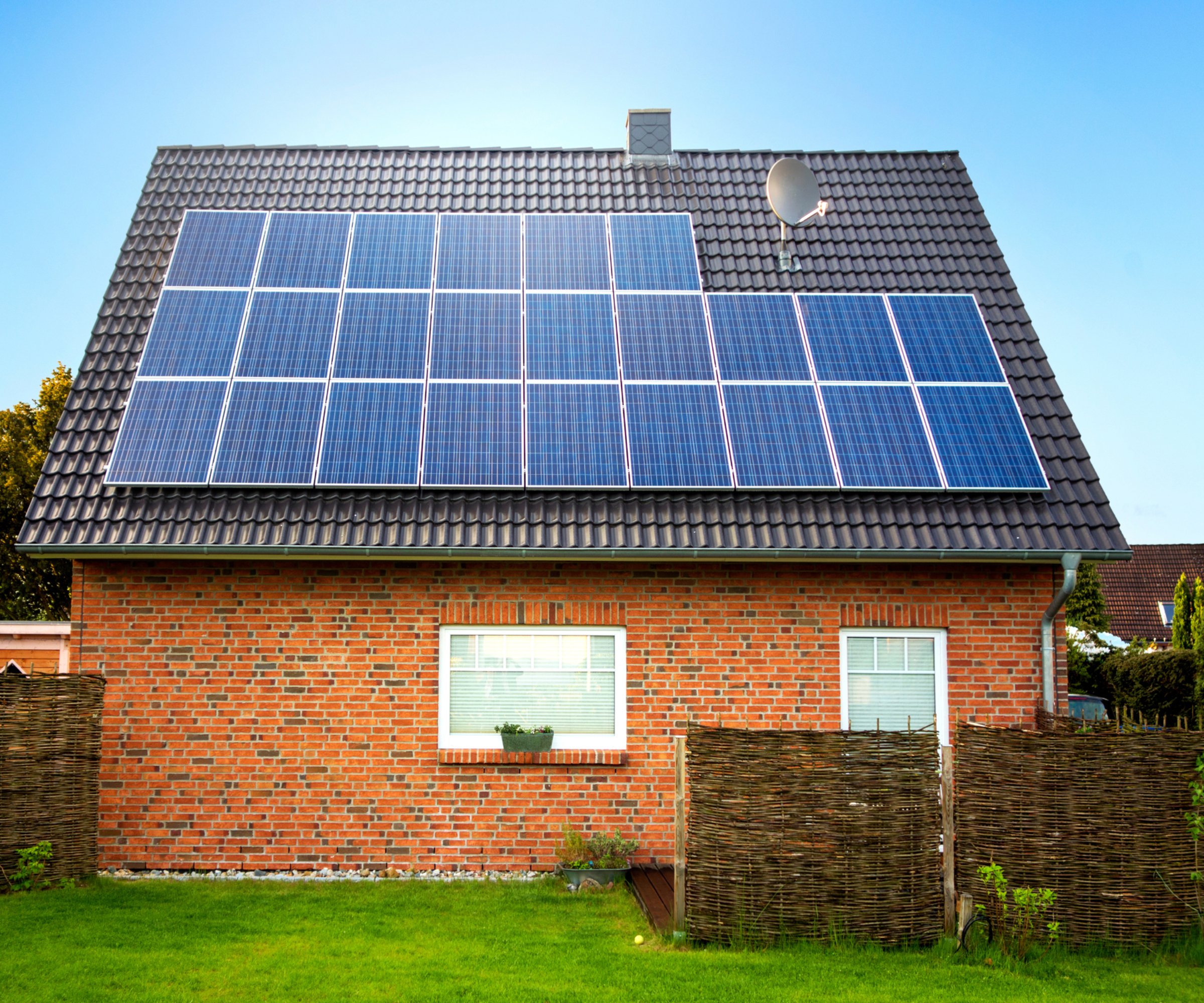 brick house with solar panels on roof