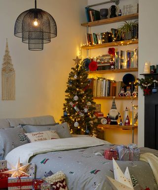 Traditional red and green Christmas bedroom with bookshelf and LED fairy lights