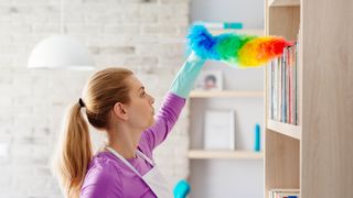 Woman cleaning with feather duster