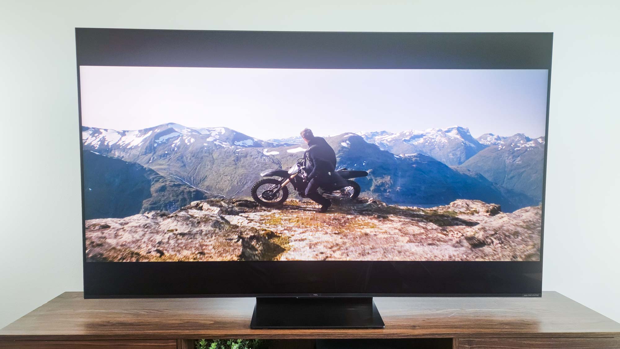 A TCL QM7K QD-Mini LED TV on a side table