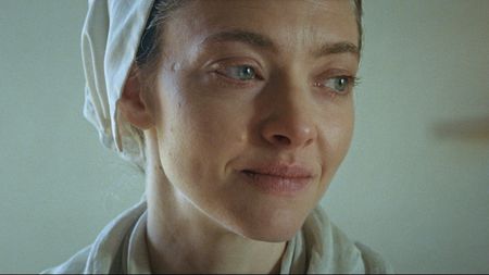 Amanda Seyfried smiling while looking to her left in The Testament of Ann Lee
