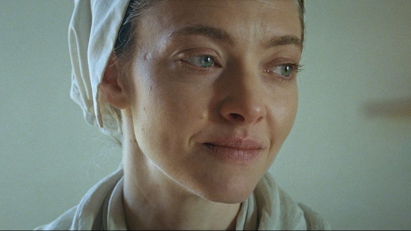 Amanda Seyfried smiling while looking to her left in The Testament of Ann Lee