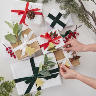 Christmas gifts being wrapped up , ribbons and bows