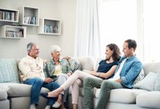 Shot of a young couple and their elderly parent spending some time together at home