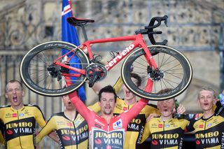 Team Jumbo's Slovenian rider Primoz Roglic holds his bike up as he celebrates with teammates after winning the 21st and final stage of the 2021 La Vuelta cycling tour of Spain, a 33.8 km time-trial race from Padron to Santiago de Compostela, on September 5, 2021. (Photo by MIGUEL RIOPA / AFP) (Photo by MIGUEL RIOPA/AFP via Getty Images)