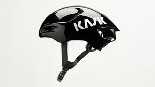 A black Kask Utopia Y aero helmet from the left hand side with the straps hanging below