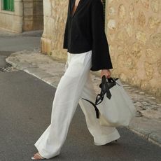 woman in white linen pants and white linen shirt