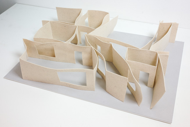 A close-up of multiple piece of card shaped in the way that looks like a 3D building plan.