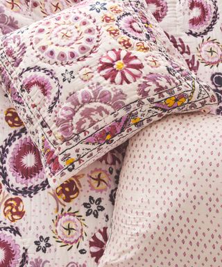 Close up of pink and purple patterned bedding from Anthropologie