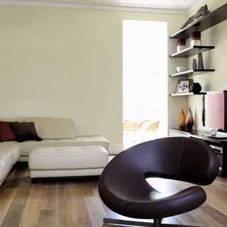 living room with leather furniture and wooden flooring