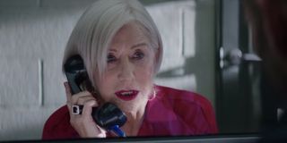 Hobbs and Shaw Queenie talks on the prison phone in her red jumpsuit
