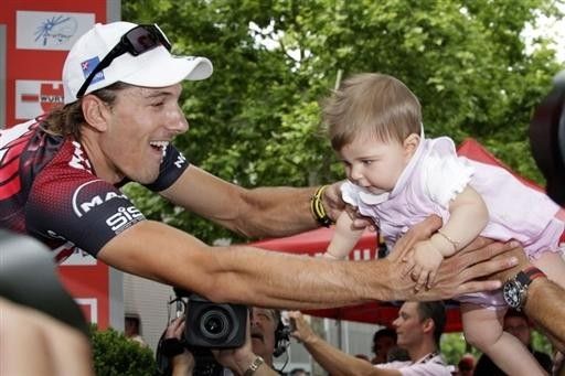Stage winner Fabian Cancellara grabs his daughter Juliana before heading to the podium.