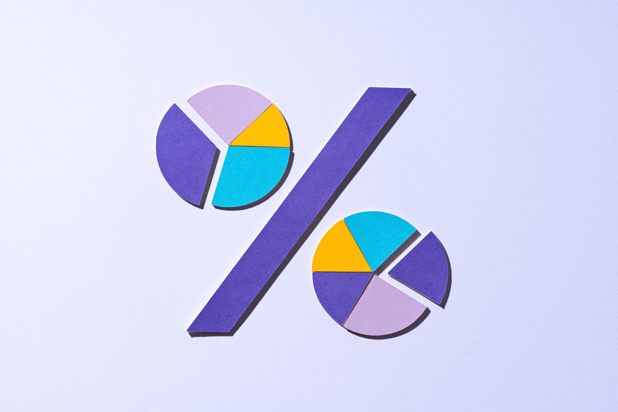 Paper Craft Percent Symbol Composed of Pie Chart Segments on Purple Background Front View