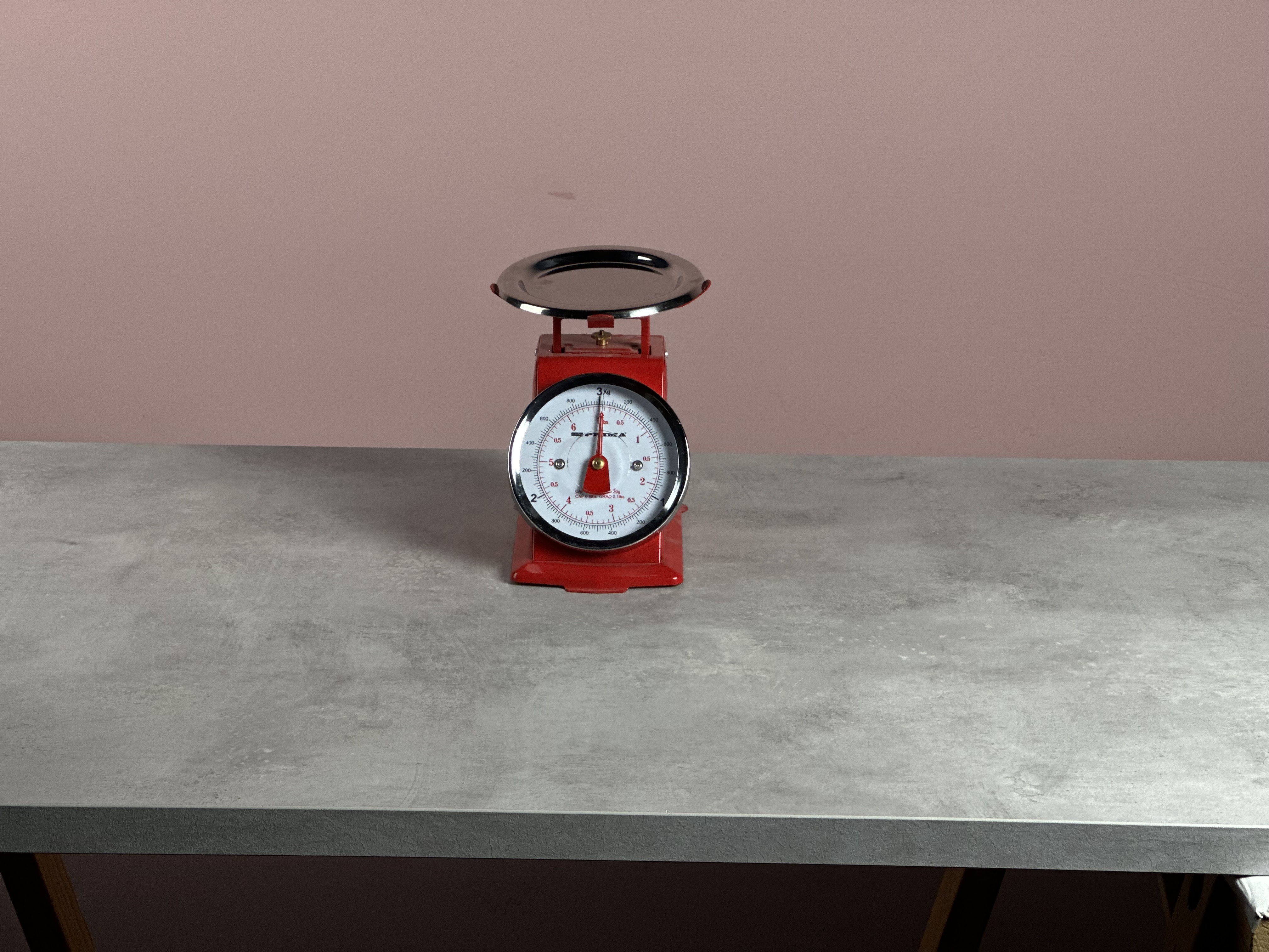 A photo of a red old fashioned analog scale shot on the iPhone 3x lens
