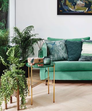 living room with table and green sofa