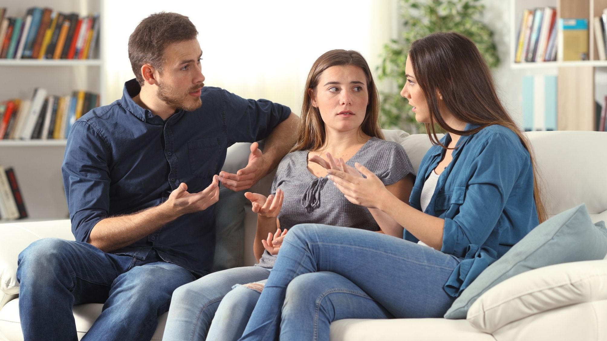 3 siblings sitting on a couch discussing important family business