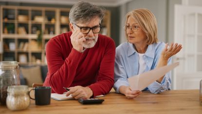 Senior couple stressing over finances at home