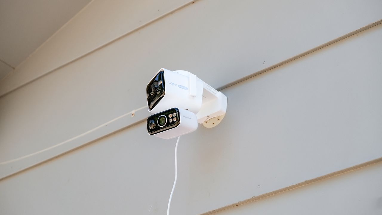 TP-Link Tapo C675D security camera mounted to the side of a house