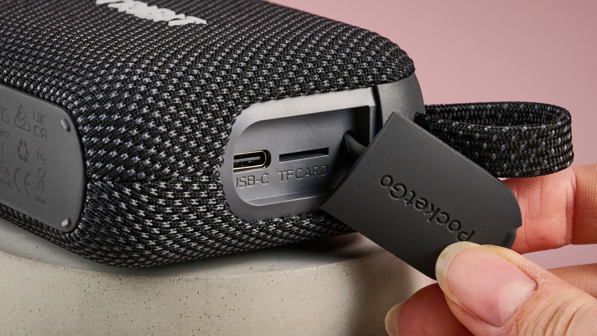 Tab on Tribit PocketGo pulled to one side, revealing USB-C and microSD card slots