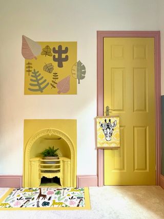 kids room with a painted yellow fireplace and door