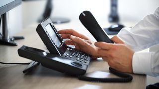 man using an office phone