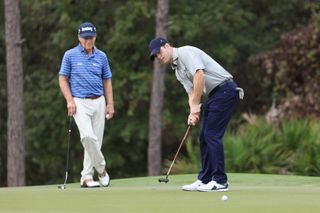 Tom and Michael Watson watch a putt at the PNC Championship