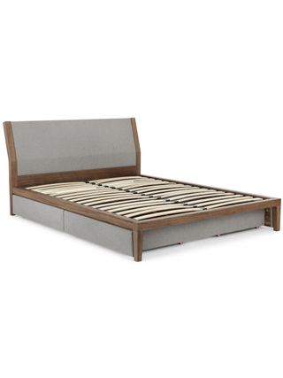 Grey upholstered storage bed with no mattress or bedding