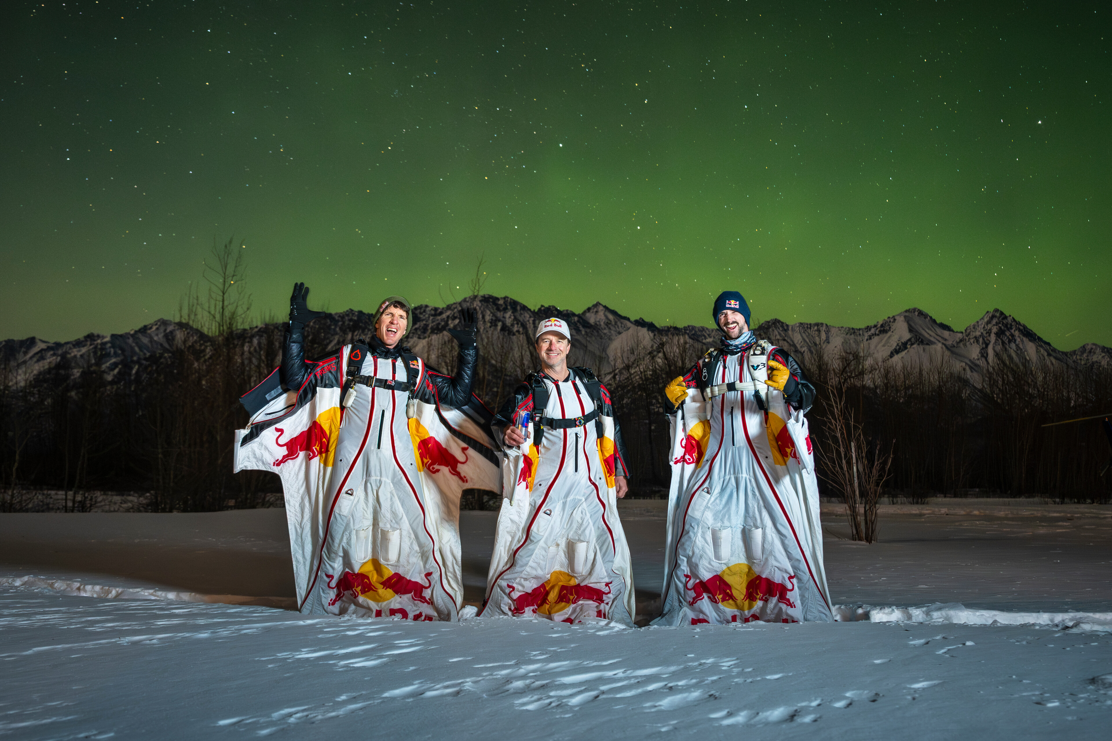 Jeff Provenzano, Jon DeVore and Mike Brewer pose for a portrait after they succesfully wingsuit skydived under the Aurora Borealis near Palmer, Alaska on, USA March 23, 2026.