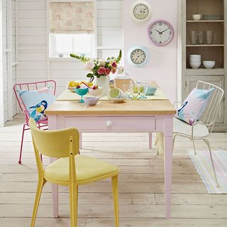 dining room with wooden table and chairs with flower vase