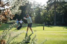 Golfers letting a single play through