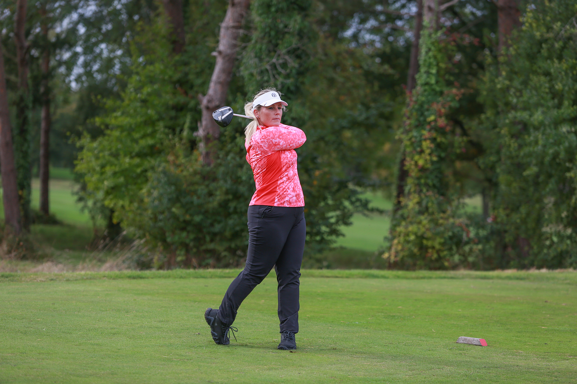 Carly Cummins in the finish position with driver after hitting a tee shot