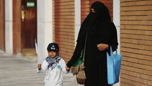 A mother and child outside an East London Mosque