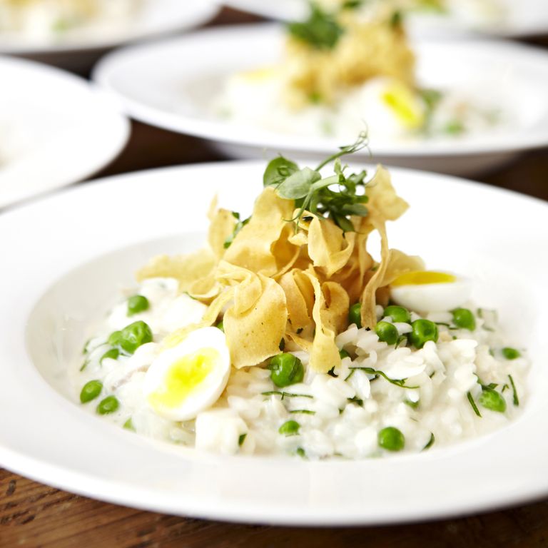 smoked haddock risotto with quail eggs and parsnip crisps photo