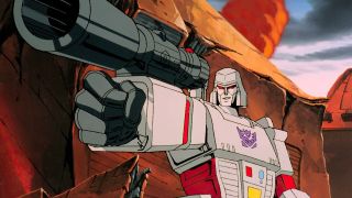 Still from the animated movie The Transformers: The Movie (1986). Here we see a robot point a gun.