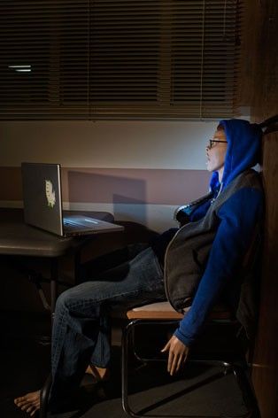 A dummy of boy looking at computer