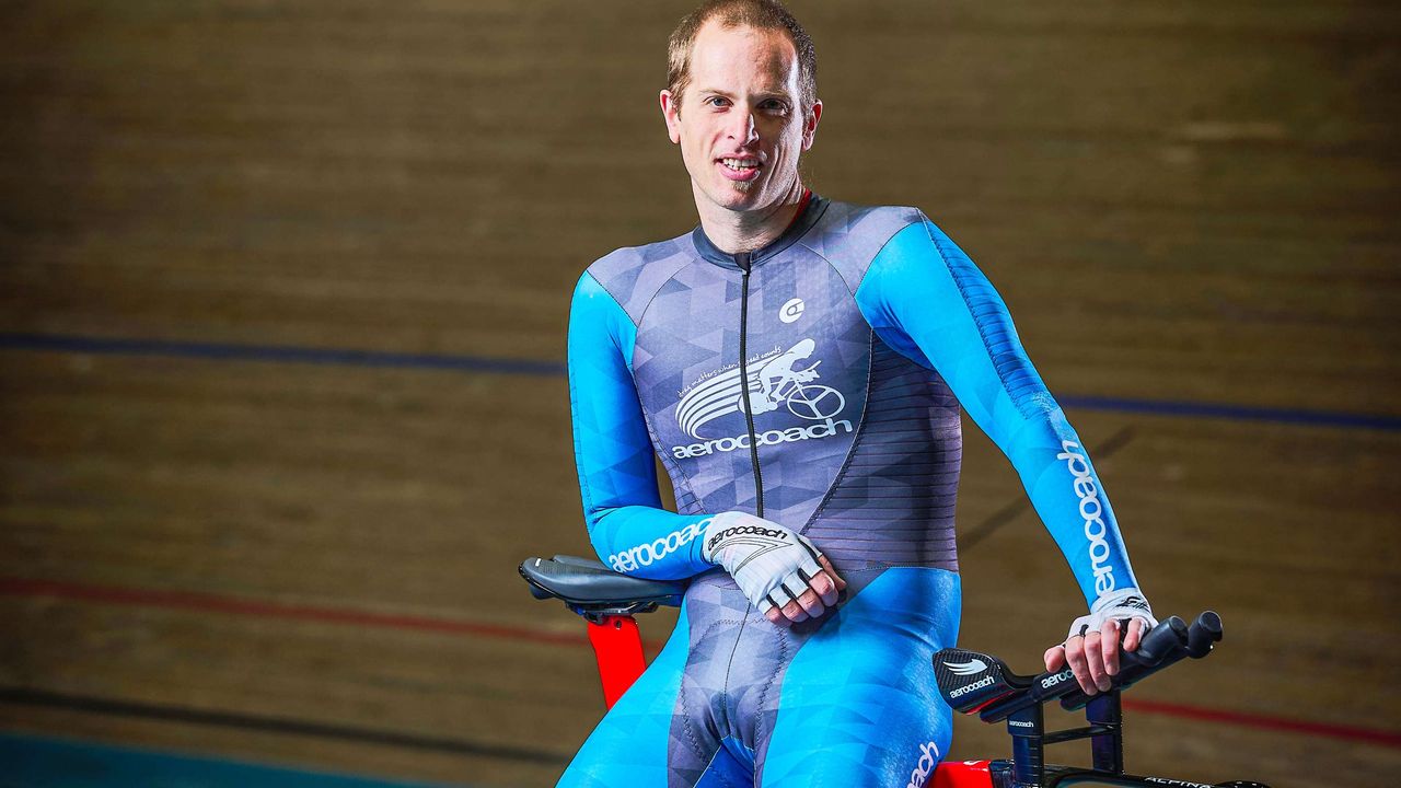 Xavier Disley stands in the velodrome with his bike