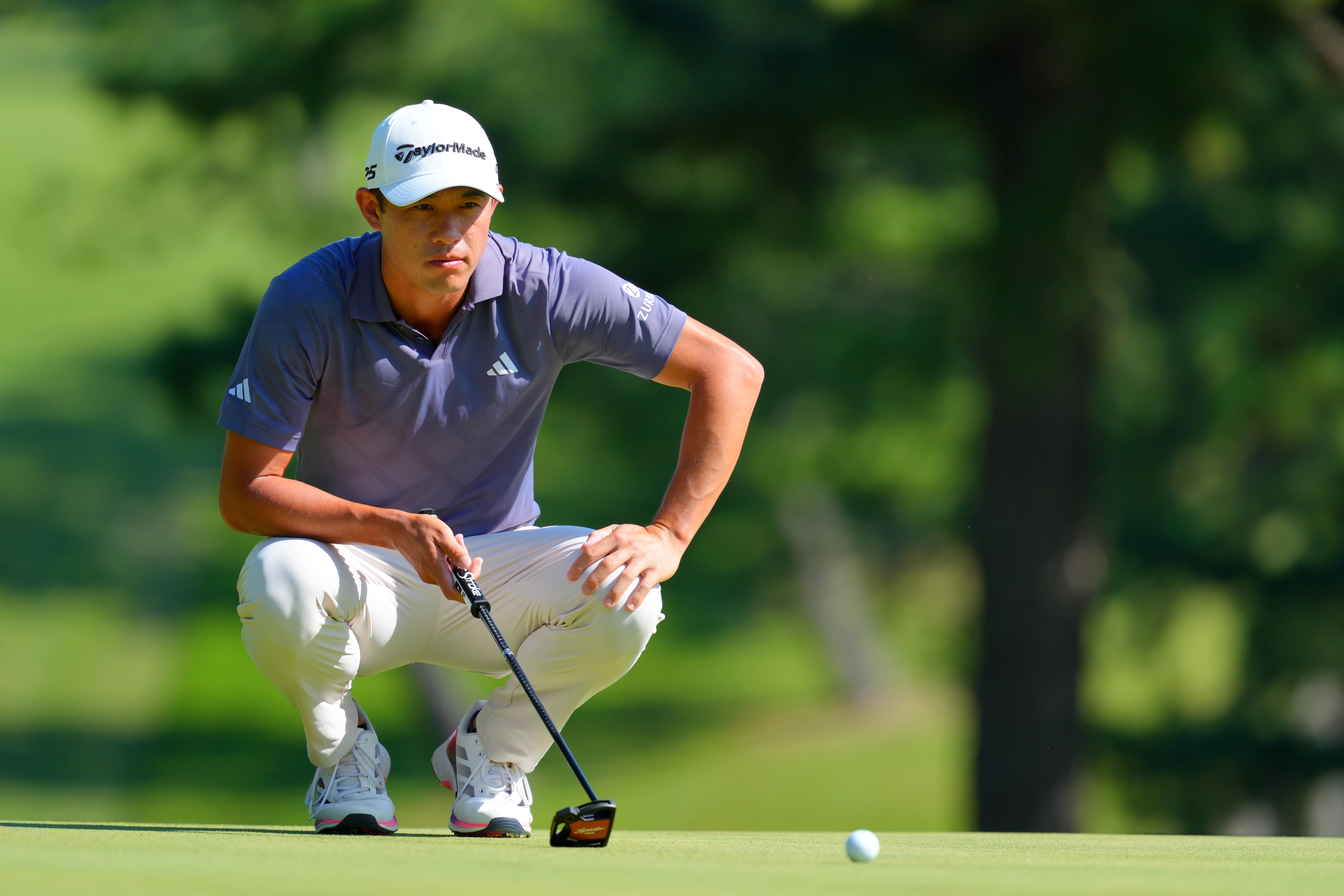 Collin Morikawa lines up a putt