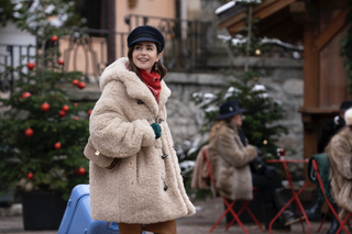 Lily Collins wears a sherpa coat and a newsboy hat.