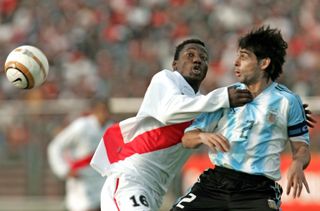 Argentina's Roberto Ayala (right) vies for the ball with Peru's Andres Mendoza at the 2004 Copa America.