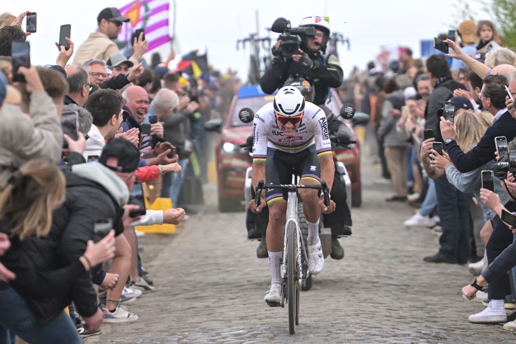 Alpecin - Deceuninck team's Dutch rider Mathieu Van Der Poel cycles in a lone breakaway ahead of the pack of riders on a cobblestone sector during the 121st edition of the Paris-Roubaix one-day classic cycling race, 260km between Compiegne and Roubaix, northern France, on April 7, 2024. (Photo by Bernard PAPON / POOL / AFP)