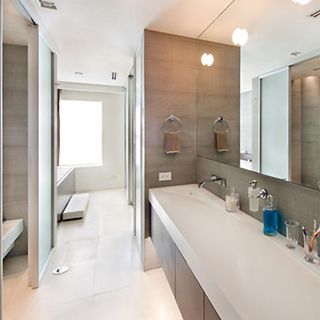 bathroom with limestone baths and mirrors
