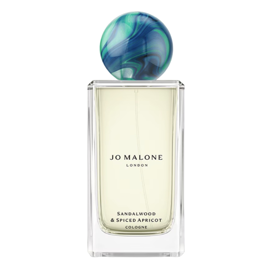 A product shot of the Jo Malone London Sandalwood and spiced apricot cologne, on a white background