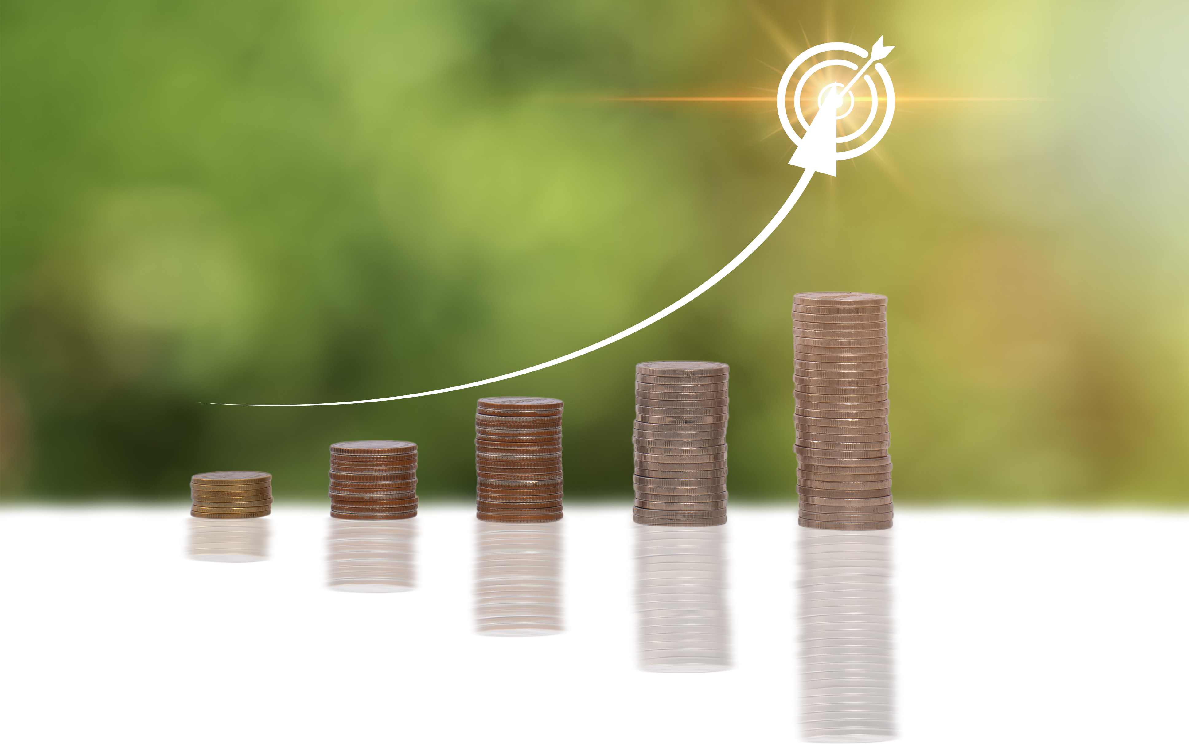 A stack of coins with a target on top, representing a goal or a target to reach