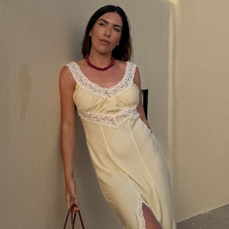 Woman in lace trim dress and beaded necklace