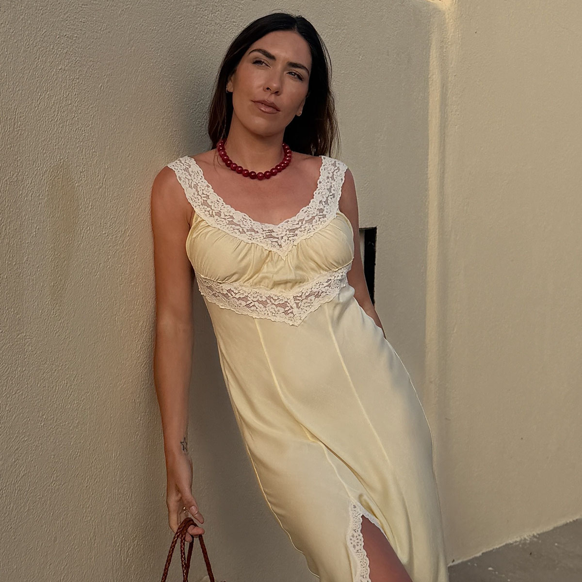Woman in lace trim dress and beaded necklace