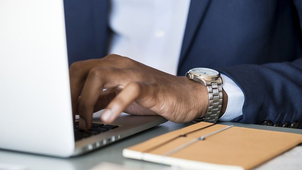 Man Typing on Laptop