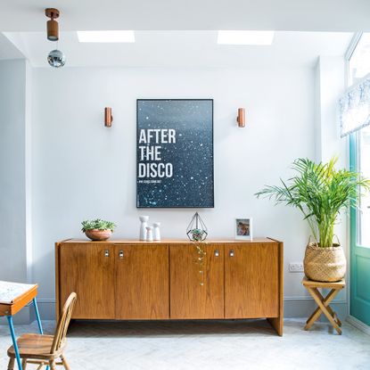 Living room with disco print above wooden sideboard